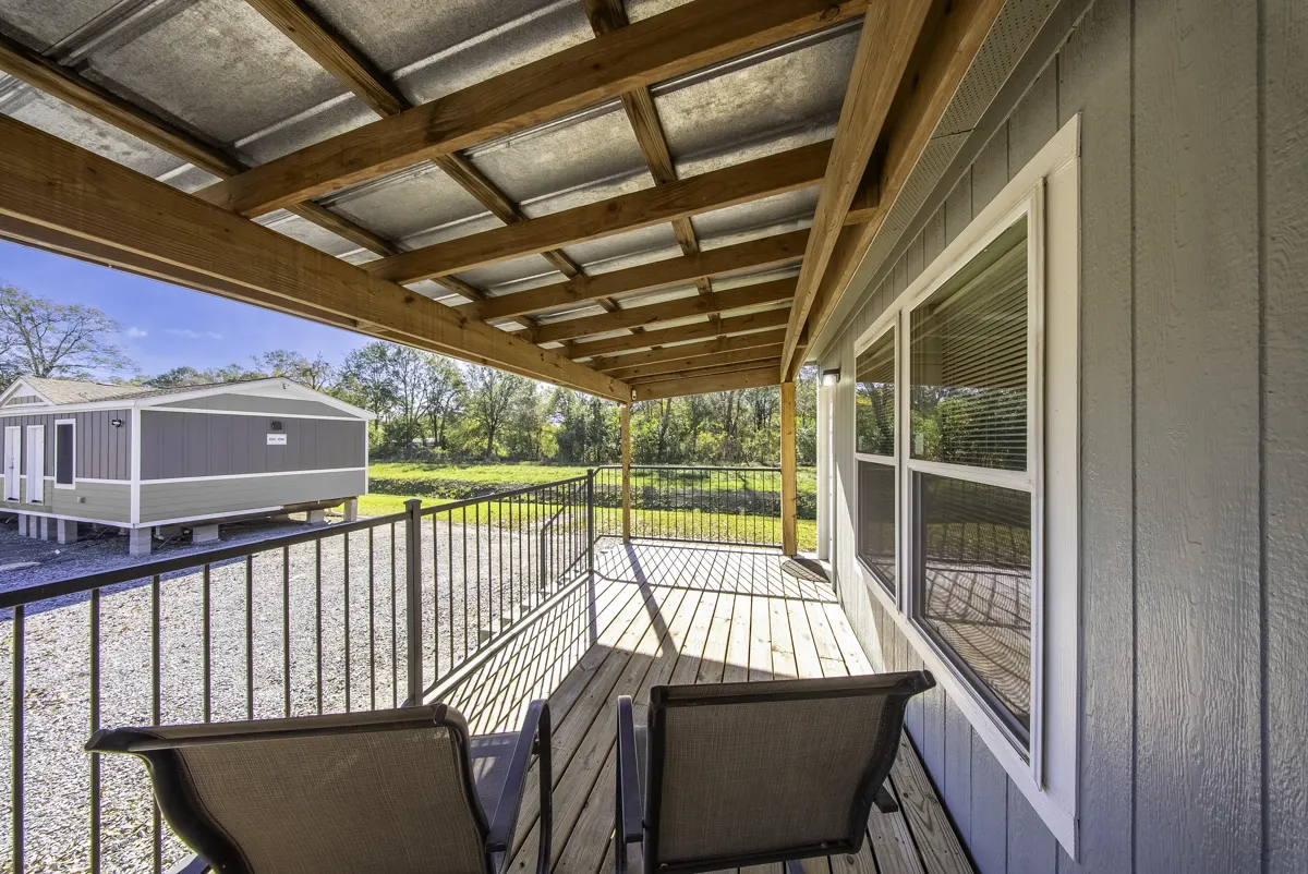 Cypress covered porch seating with a view of the field